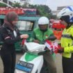 Anggota Satlantas Polres Metro Depok bersama selebgram Nabila Putri membagikan bendera merah putih di Terminal Terpadu Depok. (Dicky)